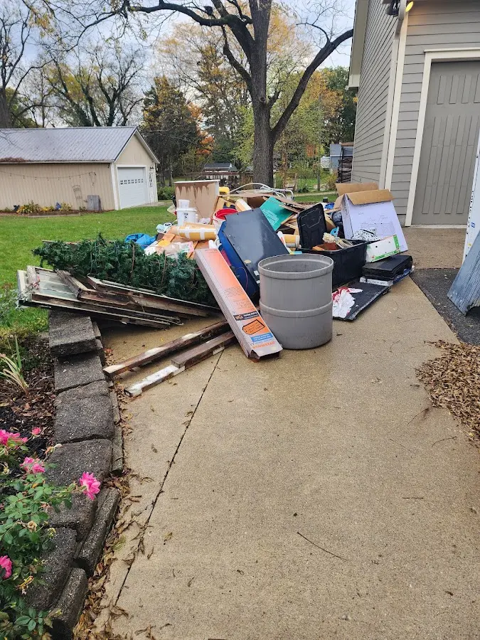 Dumpster being loaded with debris for 12 Yard Dumpster Rental in Ledyard